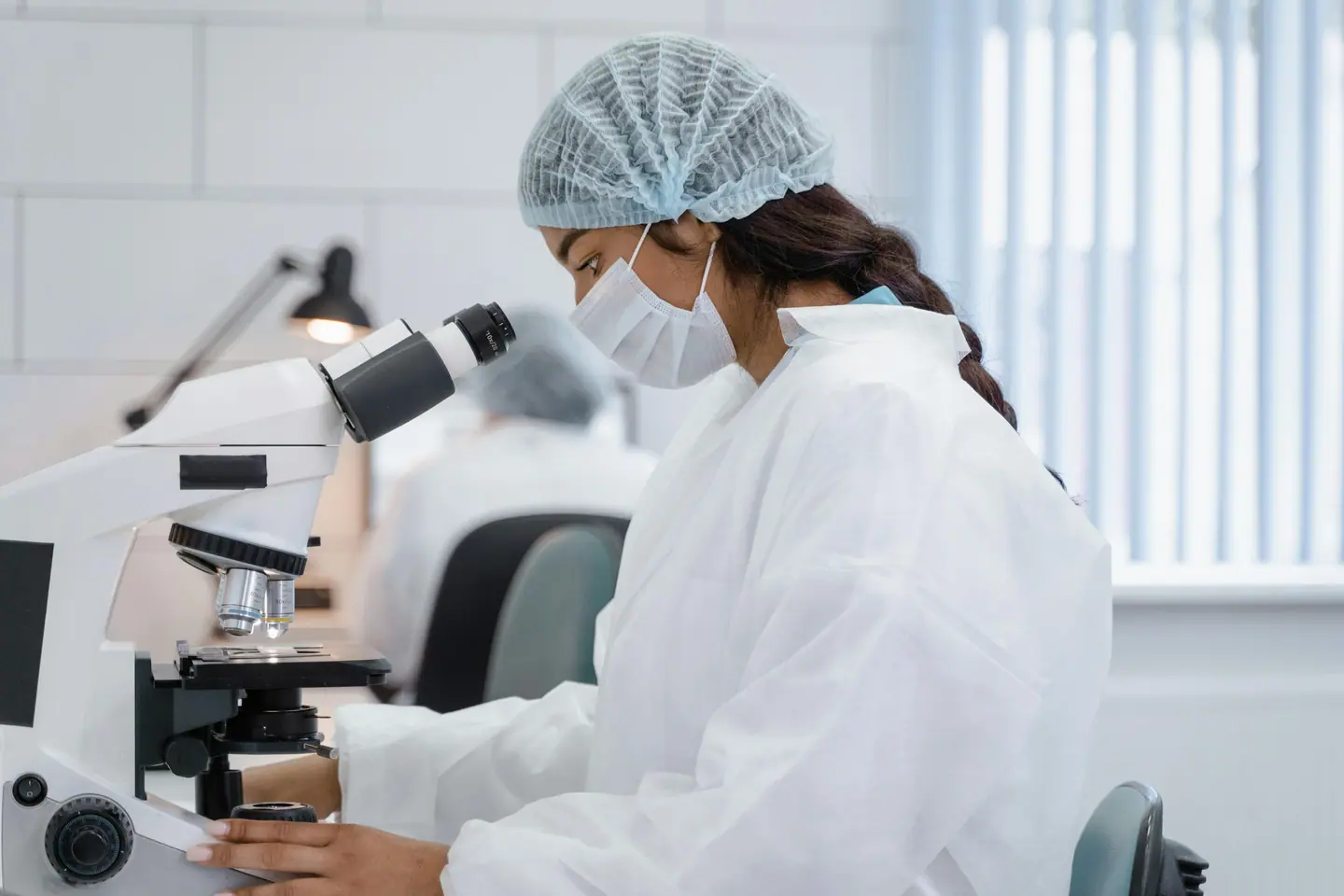 Researcher at a microscope in a probiotic laboratory